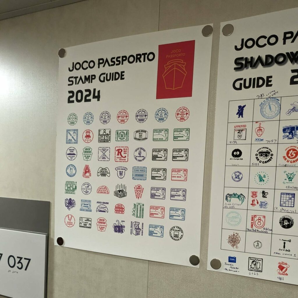 Decorations outside the room of the people who created the JoCo Passporto. Two large posters are covered in JoCoCruise themed passport stamps.